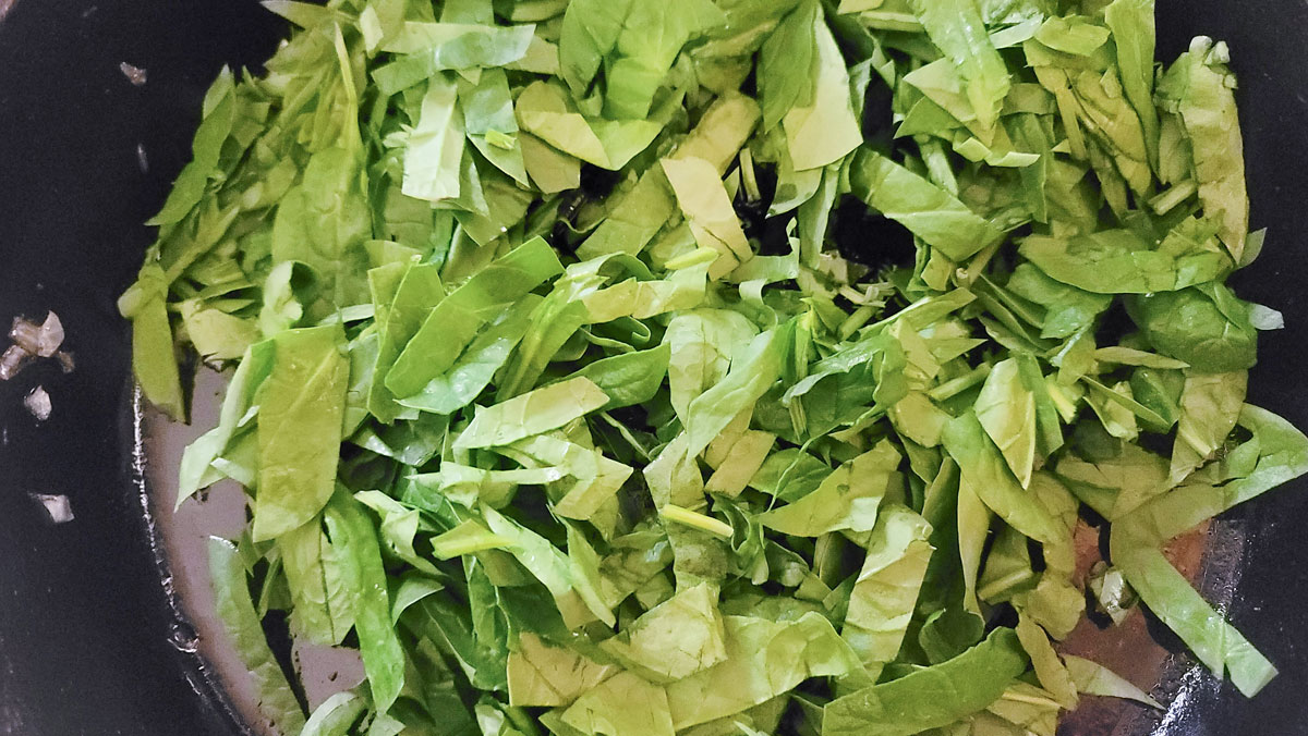 Spinach added to the same cast iron frying pan.