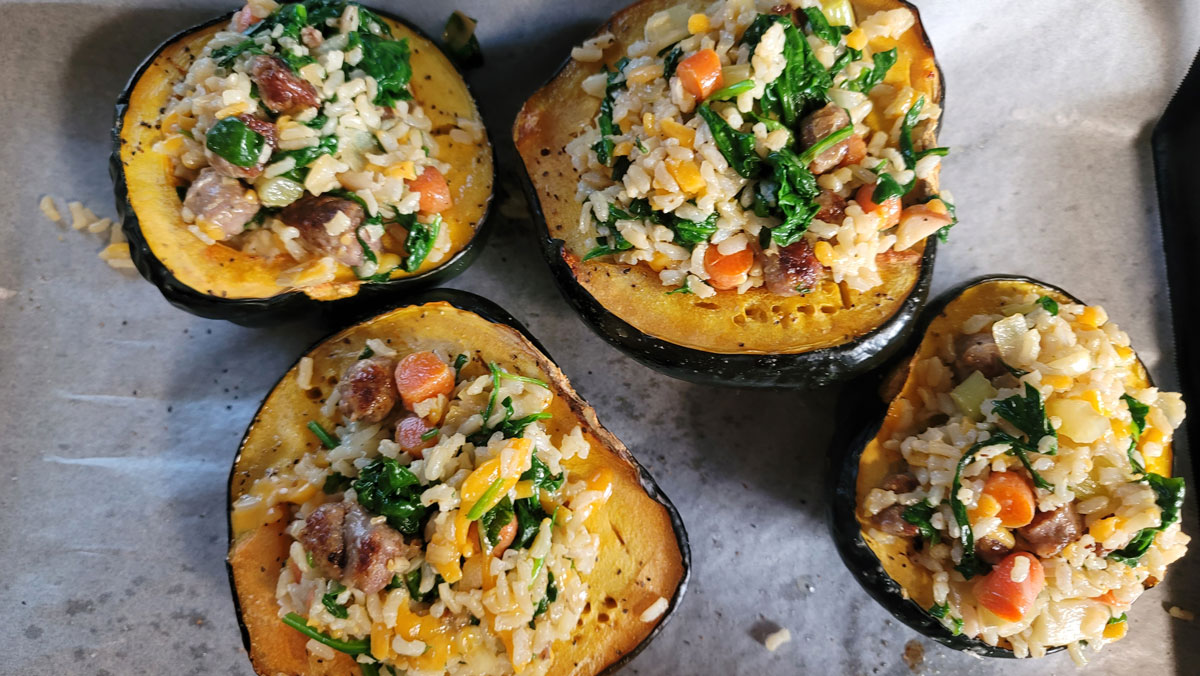 Acorn squash halves filled with the colorful filling.