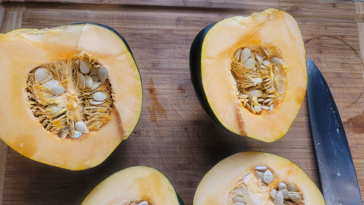 Acorn squash cut in half with seeds.