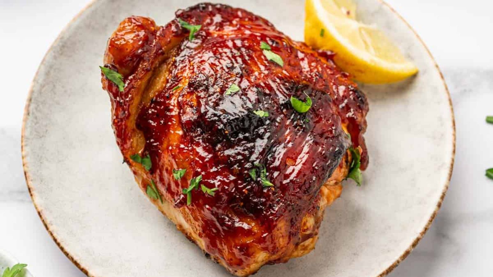 BBQ chicken thigh on a plate.