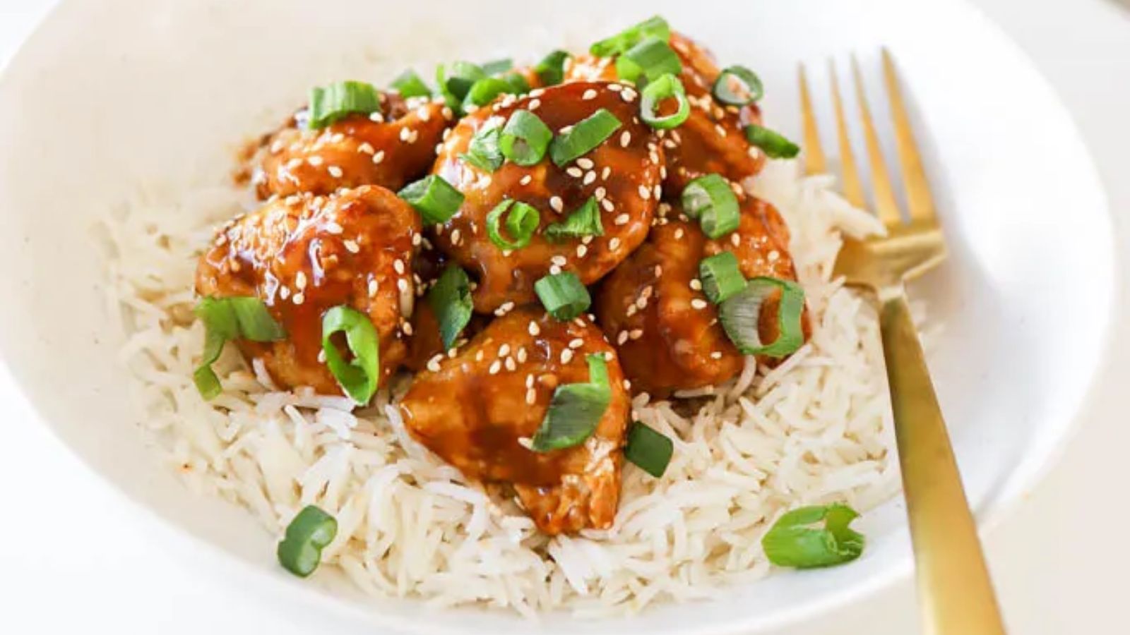 Orange chicken with rice in a bowl.