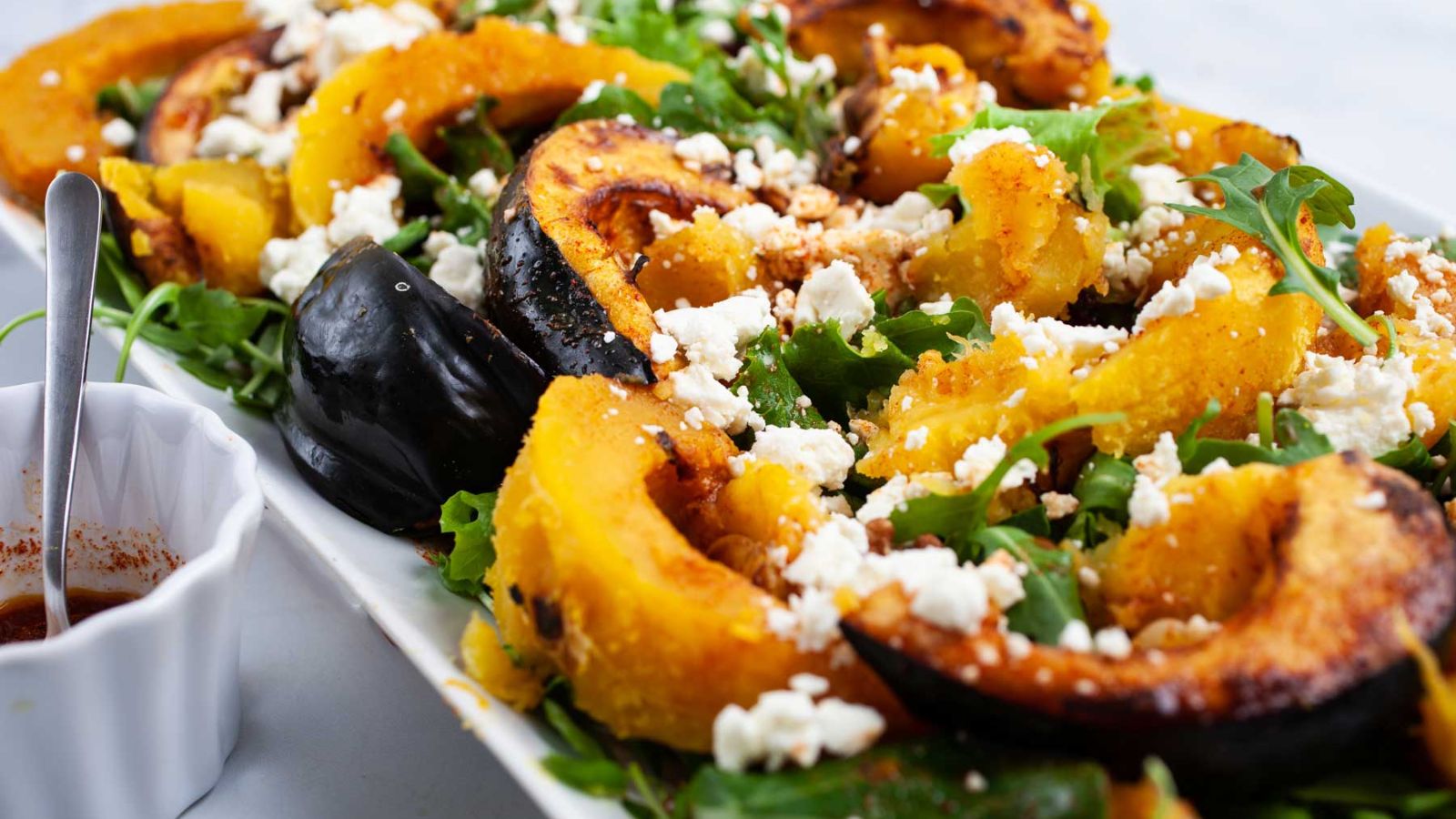 Roasted acorn squash salad on a plate.