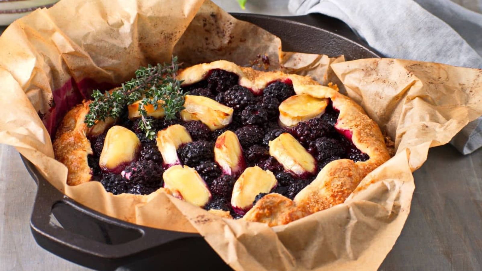 Blackberry brie galette on a parchment paper.