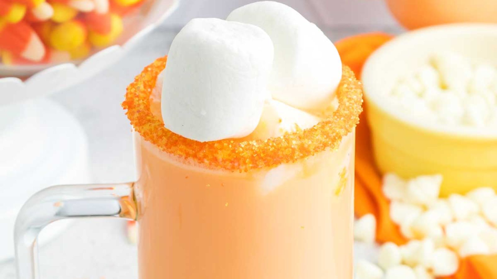 Candy corn hot chocolate in a glass.