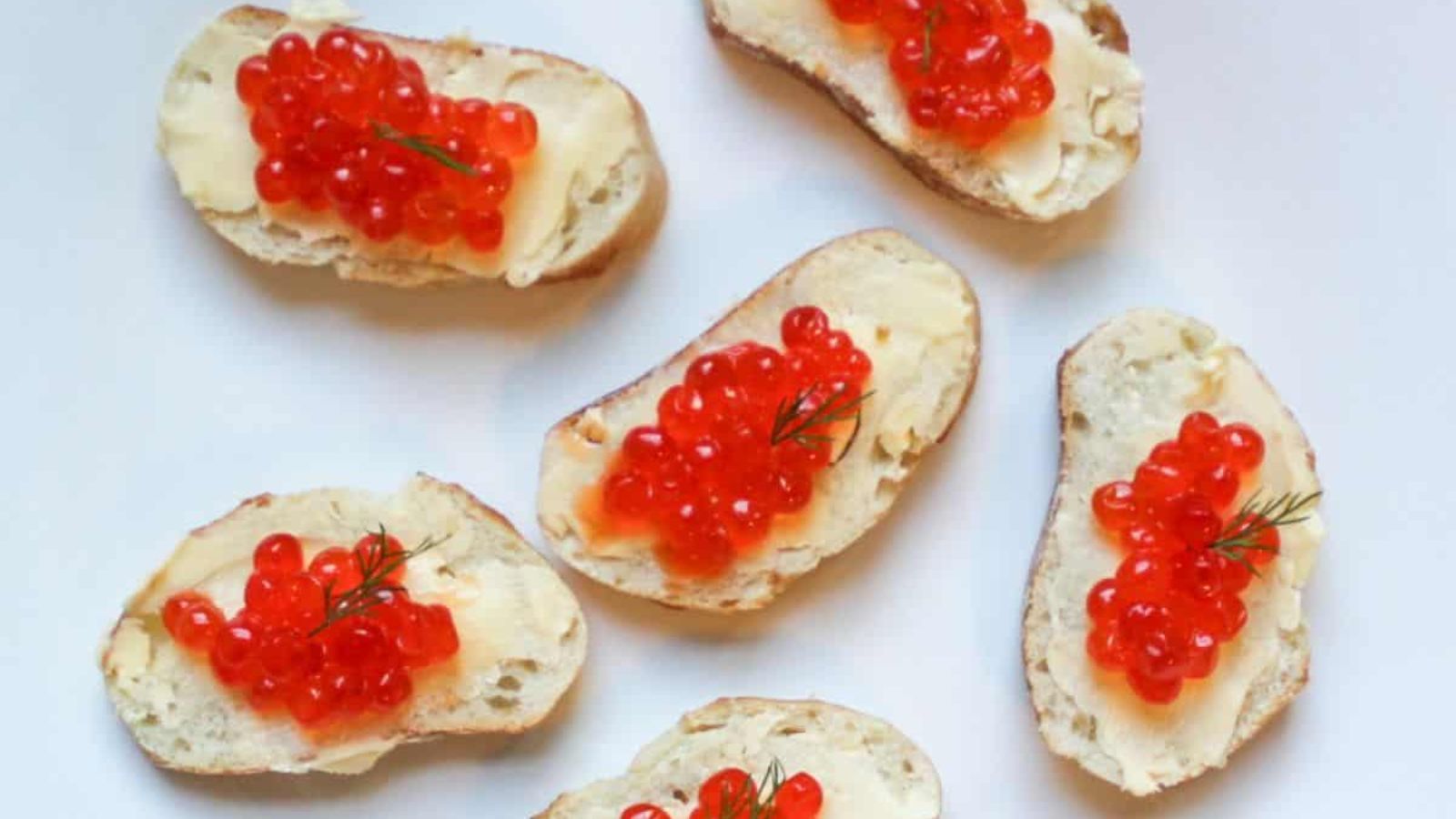 Canapes with caviar on a plate.