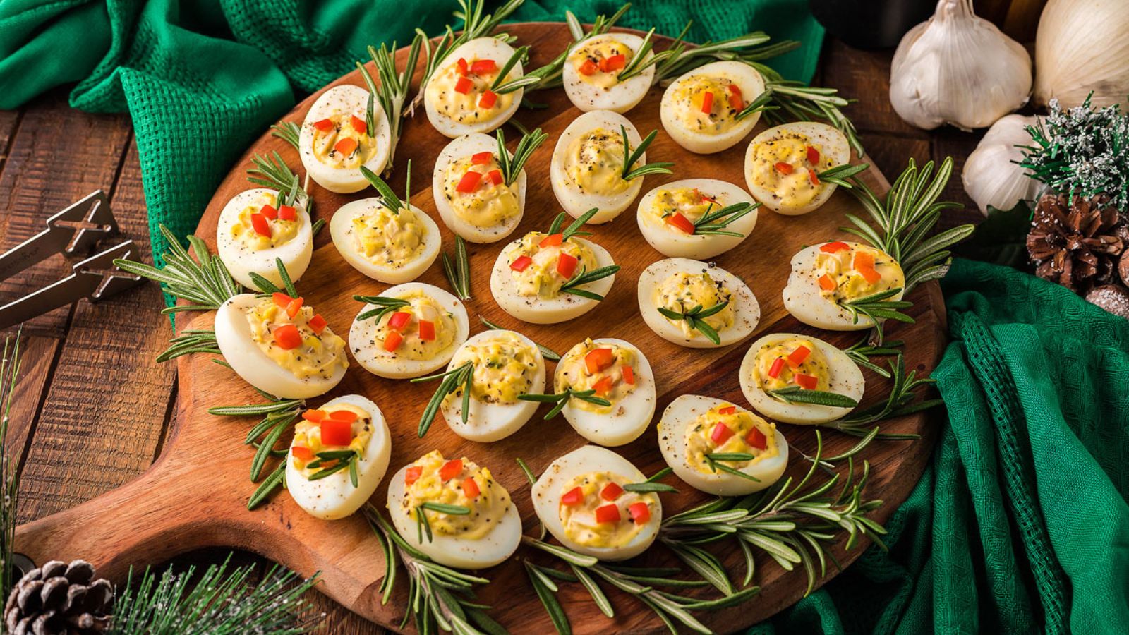 Deviled eggs on a wooden board.