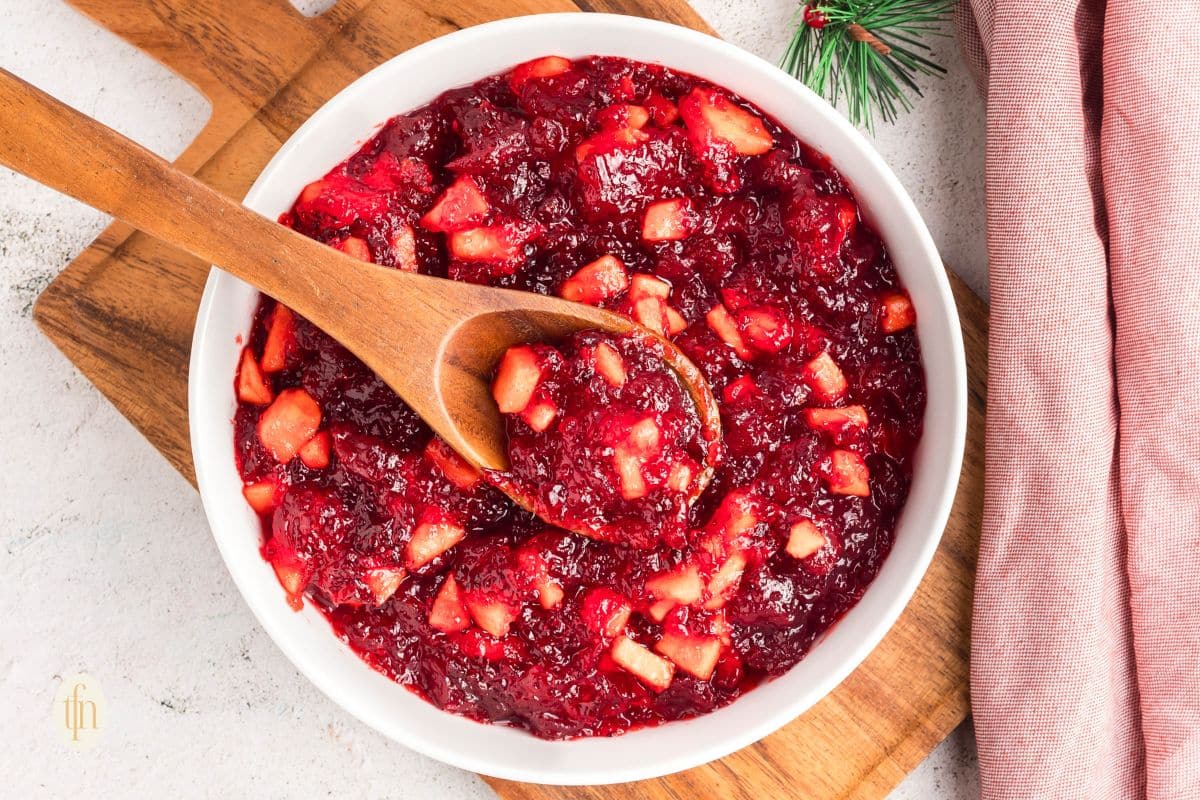 Wooden spoon scooping jello from a bowl.