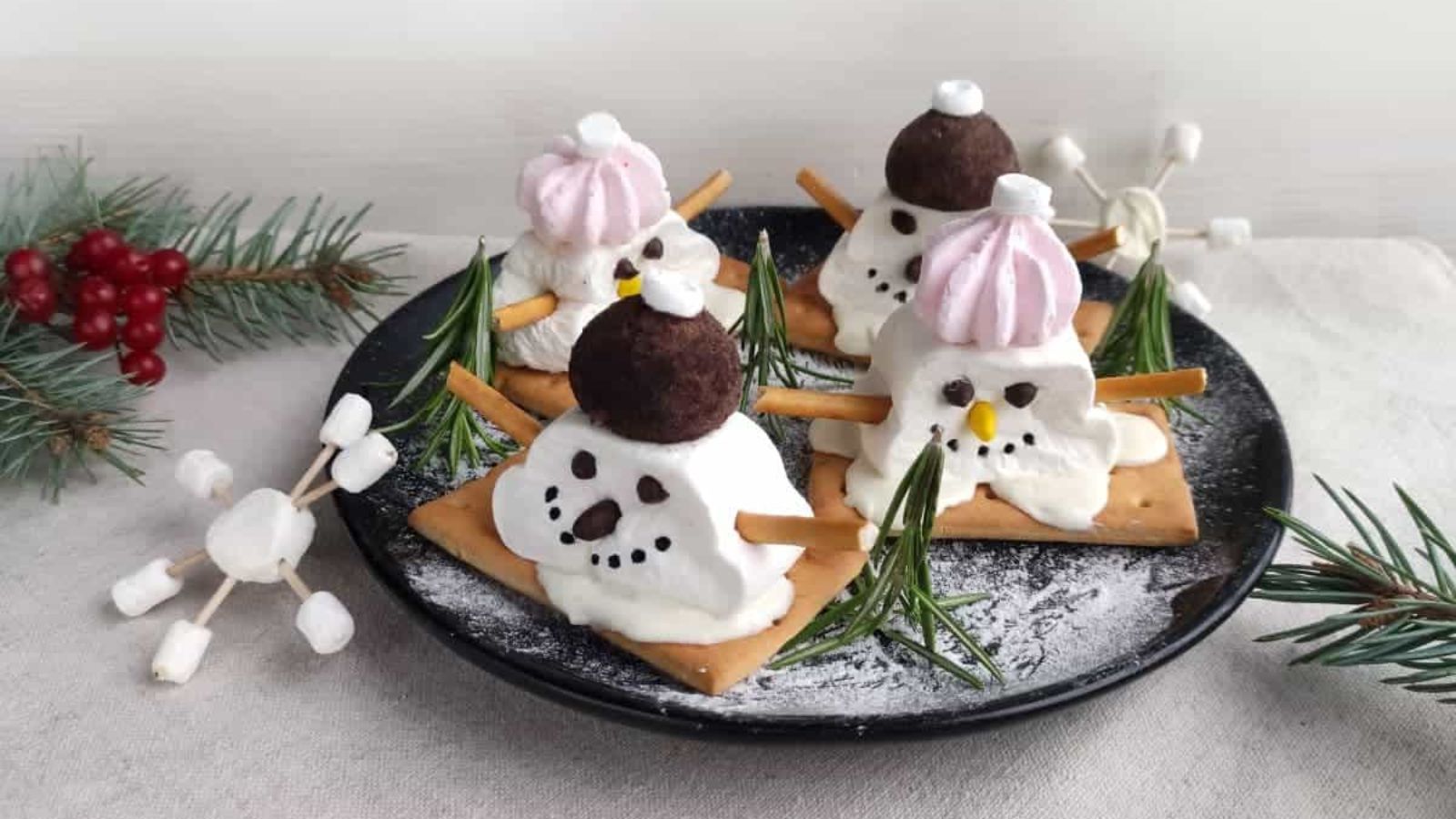 Snowman marshmallows on a plate.