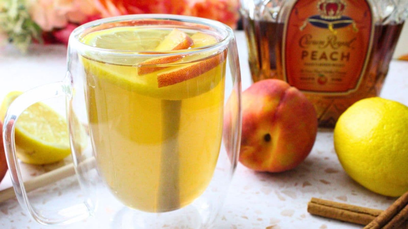 Cocktail with sliced peaches.
