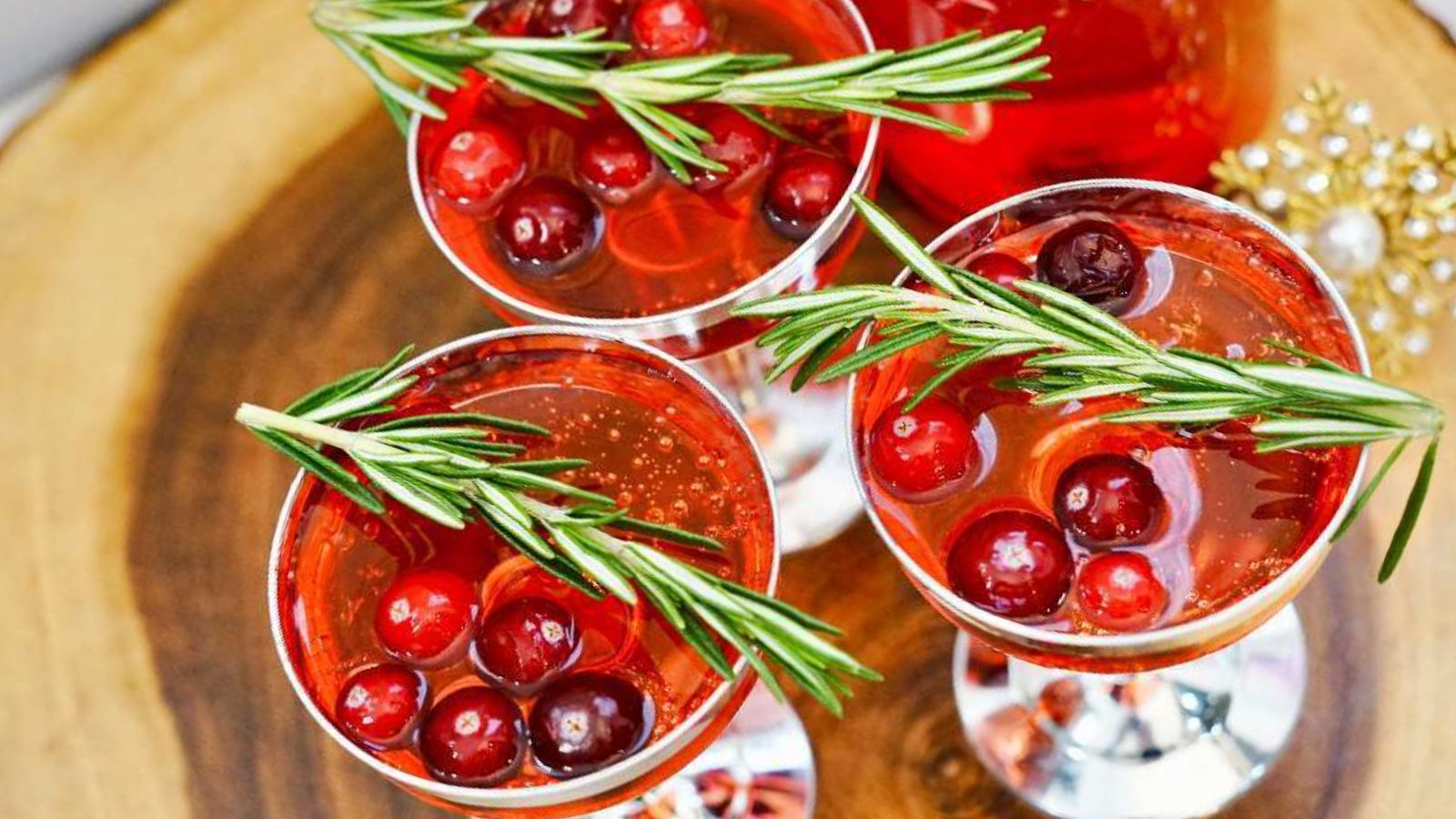 Cranberry mimosa in three cocktail glasses.