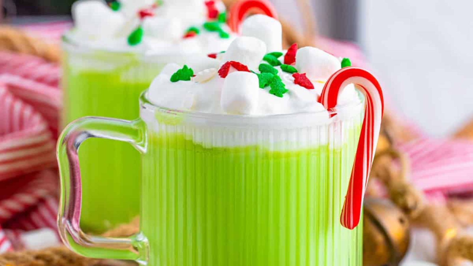 Green drink in a glass with candy cane.