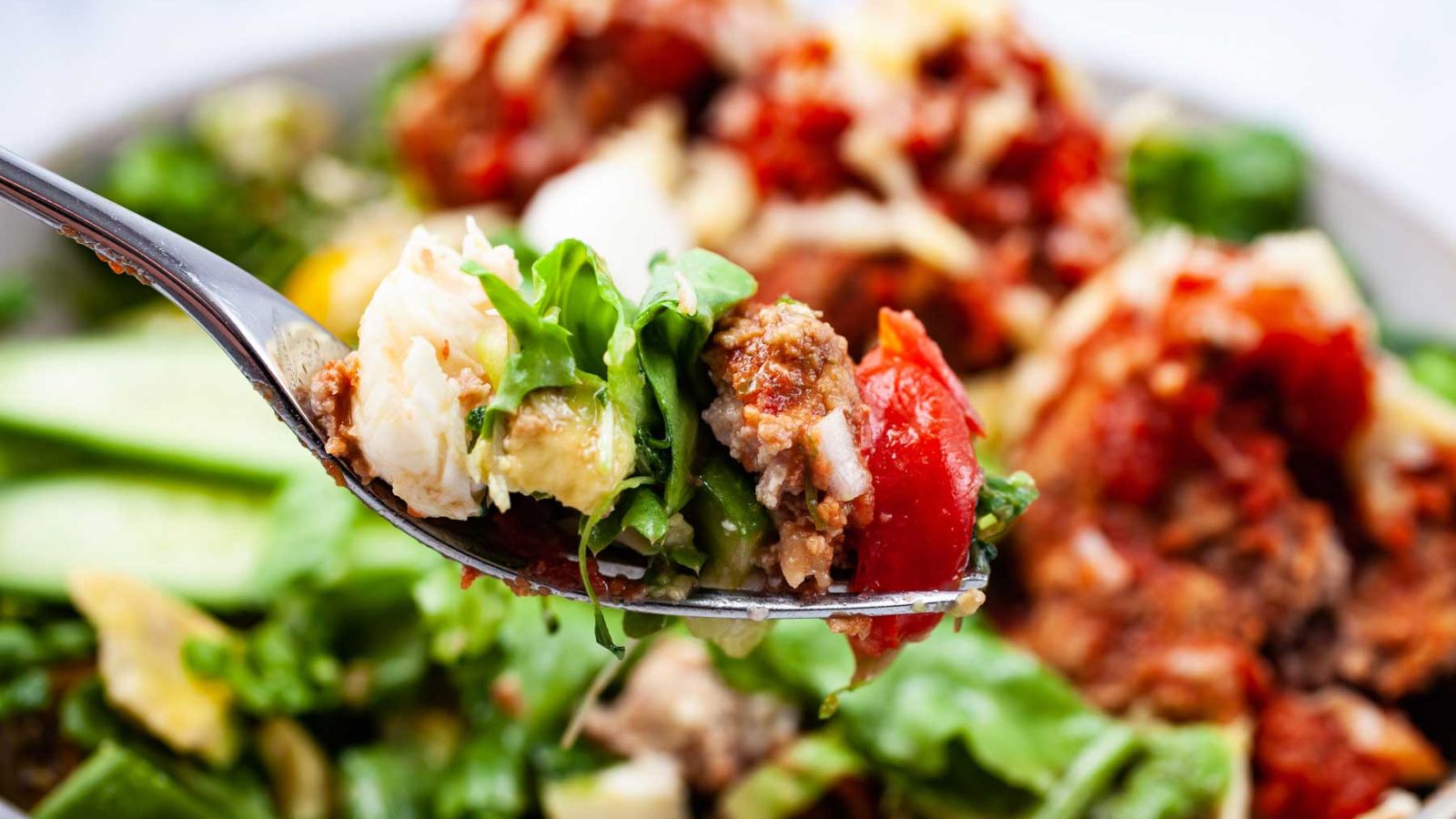 A spoonful of meatball salad.