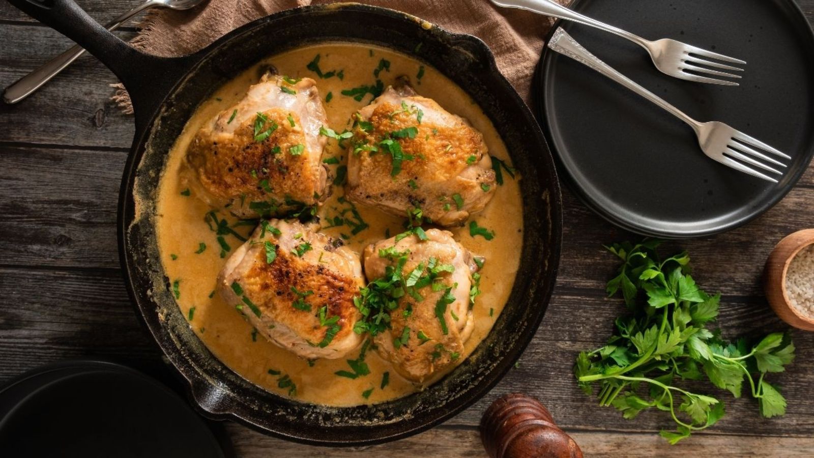 Chicken thighs in a pan.