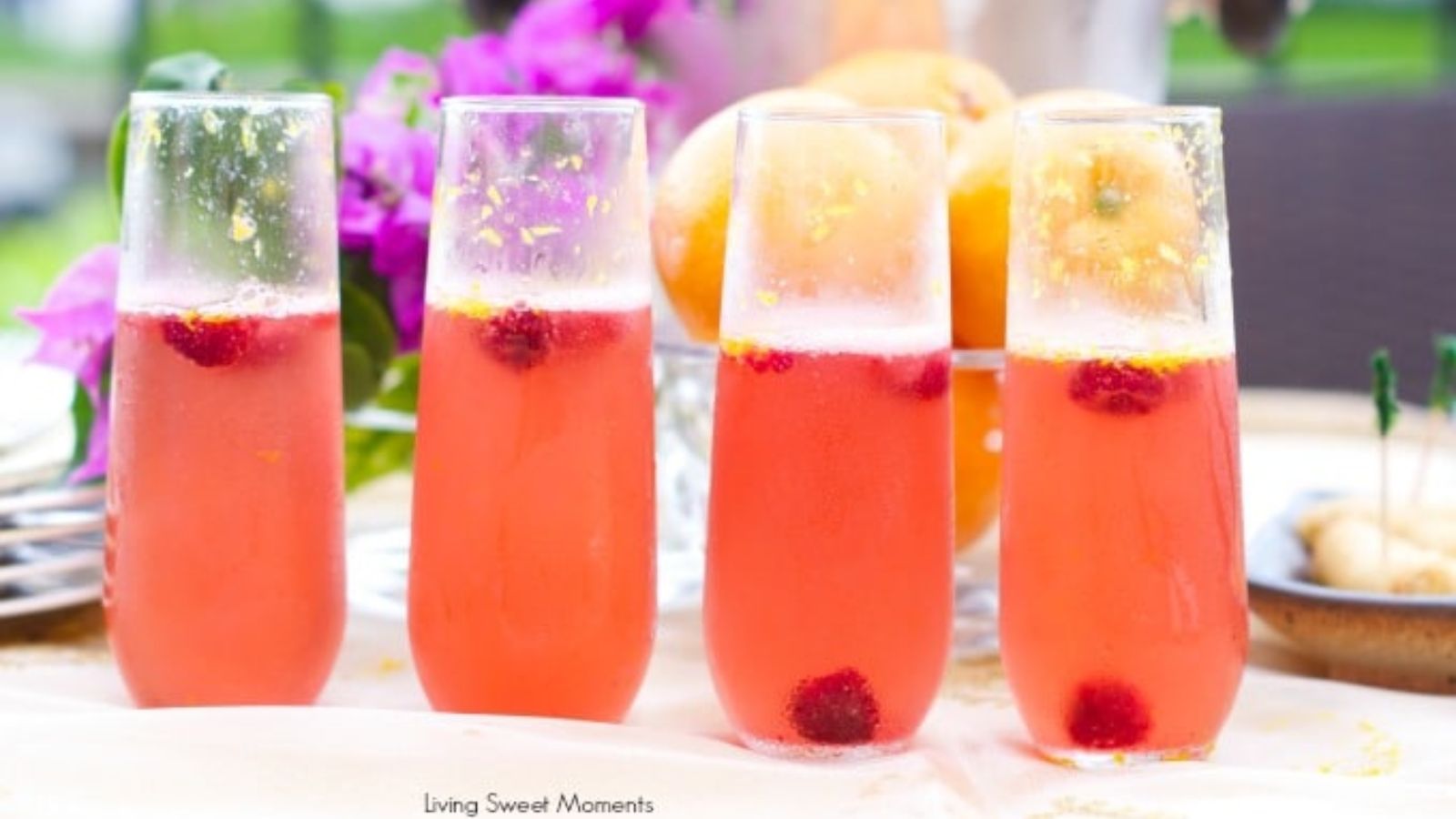 Orange raspberry cocktails in four glasses.
