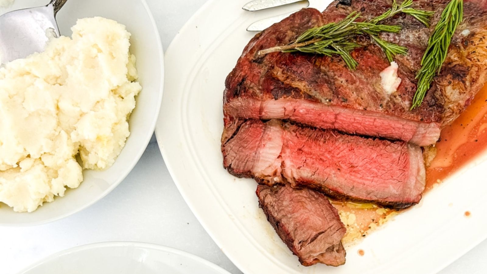 Ribeye steak with mashed potato on the side.