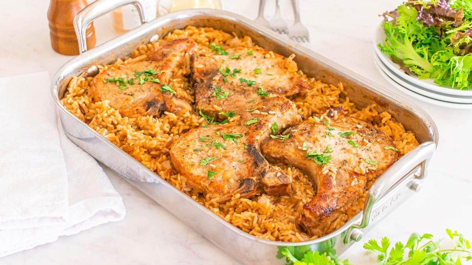Pork chop and rice on a tray.