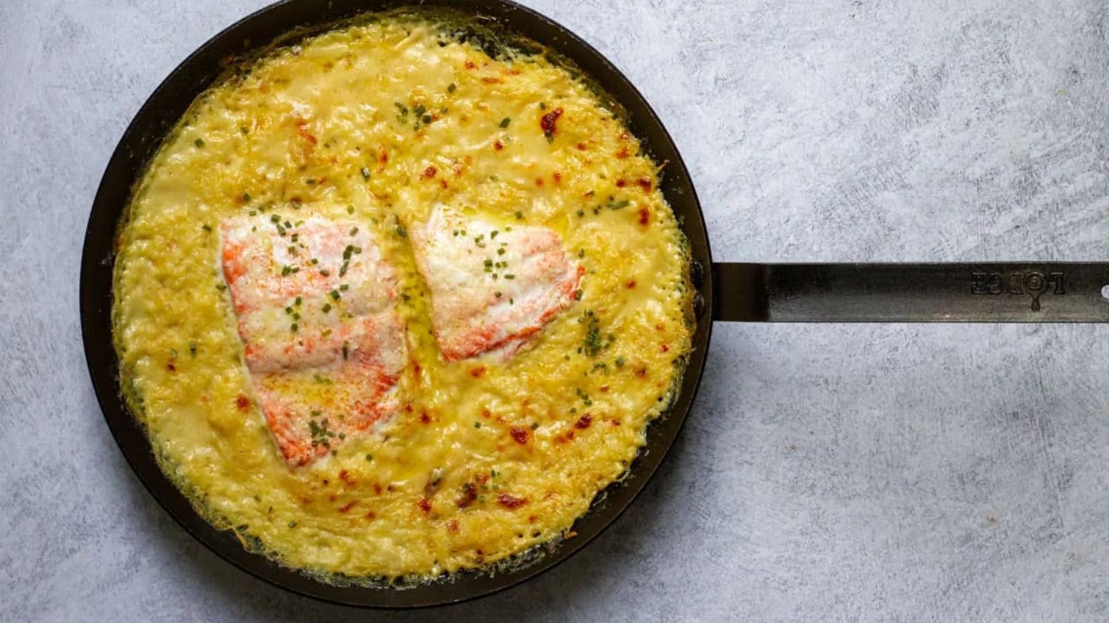 Spaghetti with salmon in a pan.