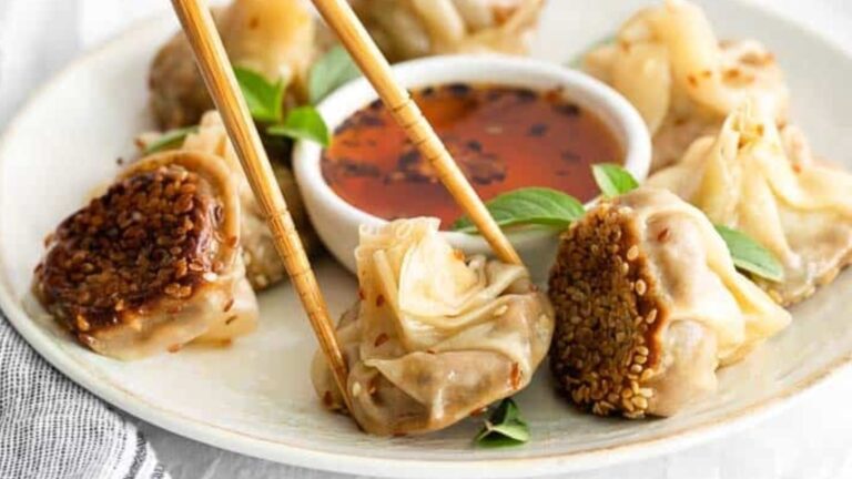 A dumpling picking up with chopsticks.