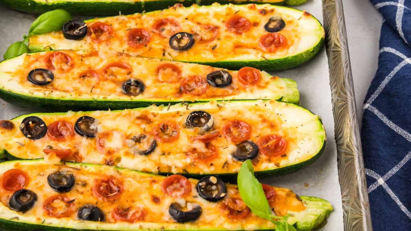 Zucchini pizza boats on a tray.