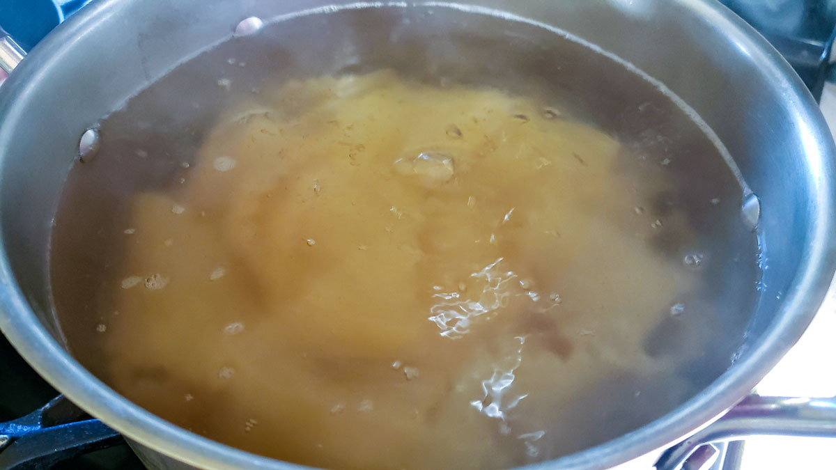 Boiling the lasagna in a stockpot.