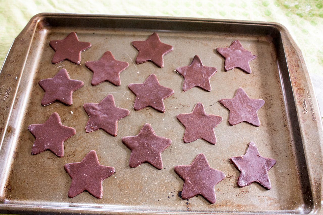 Unbaked cookies on a rimmed baking sheet.