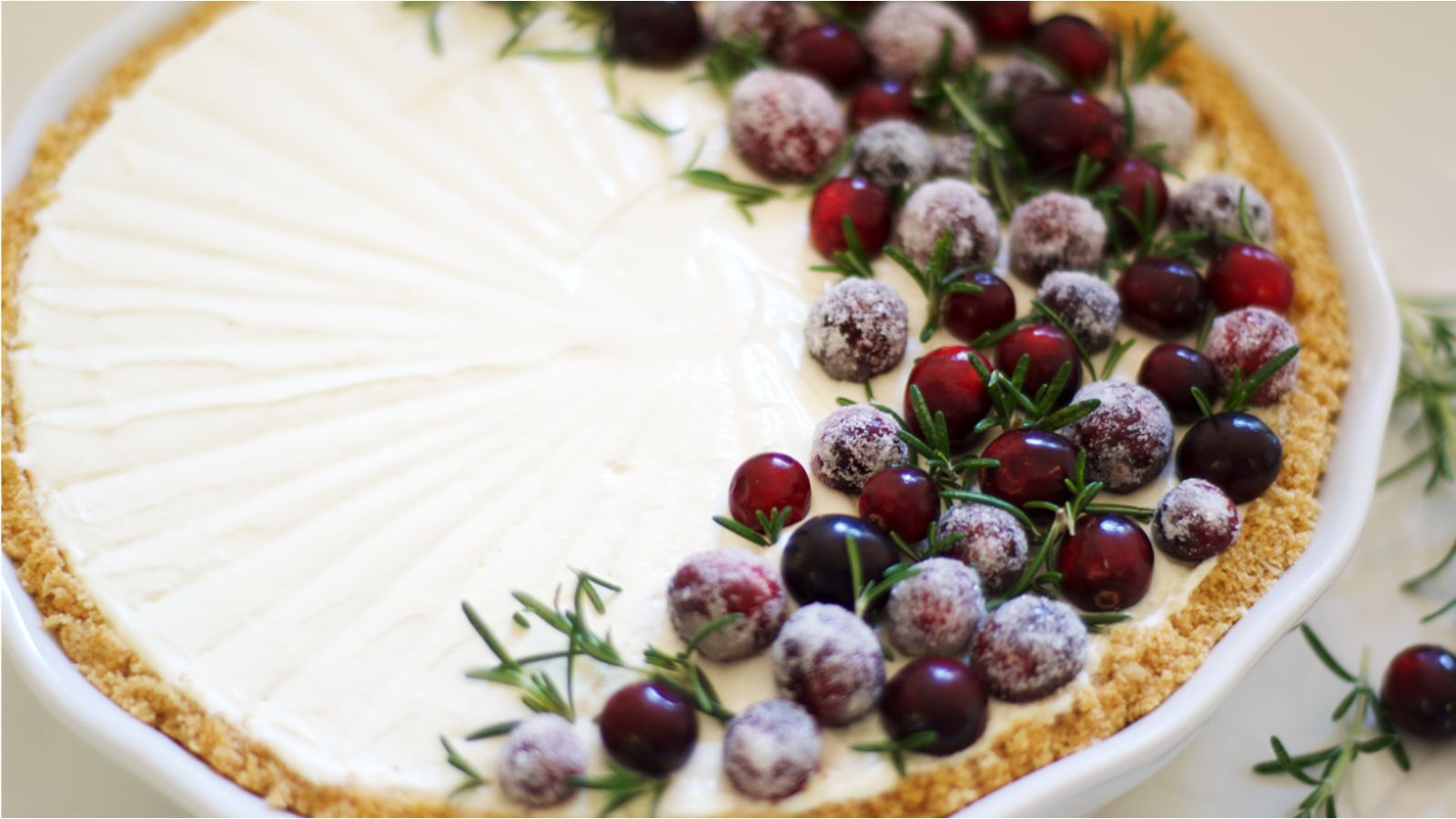 Beautiful cheesecake with cranberries and rosemary.