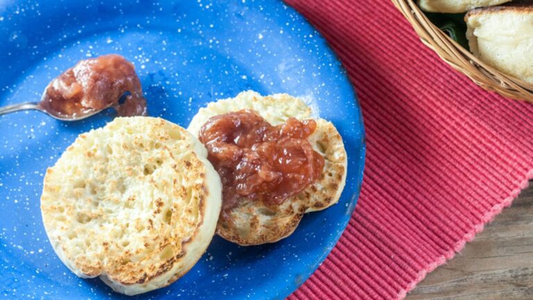 Toasted English muffin with strawberry jam.