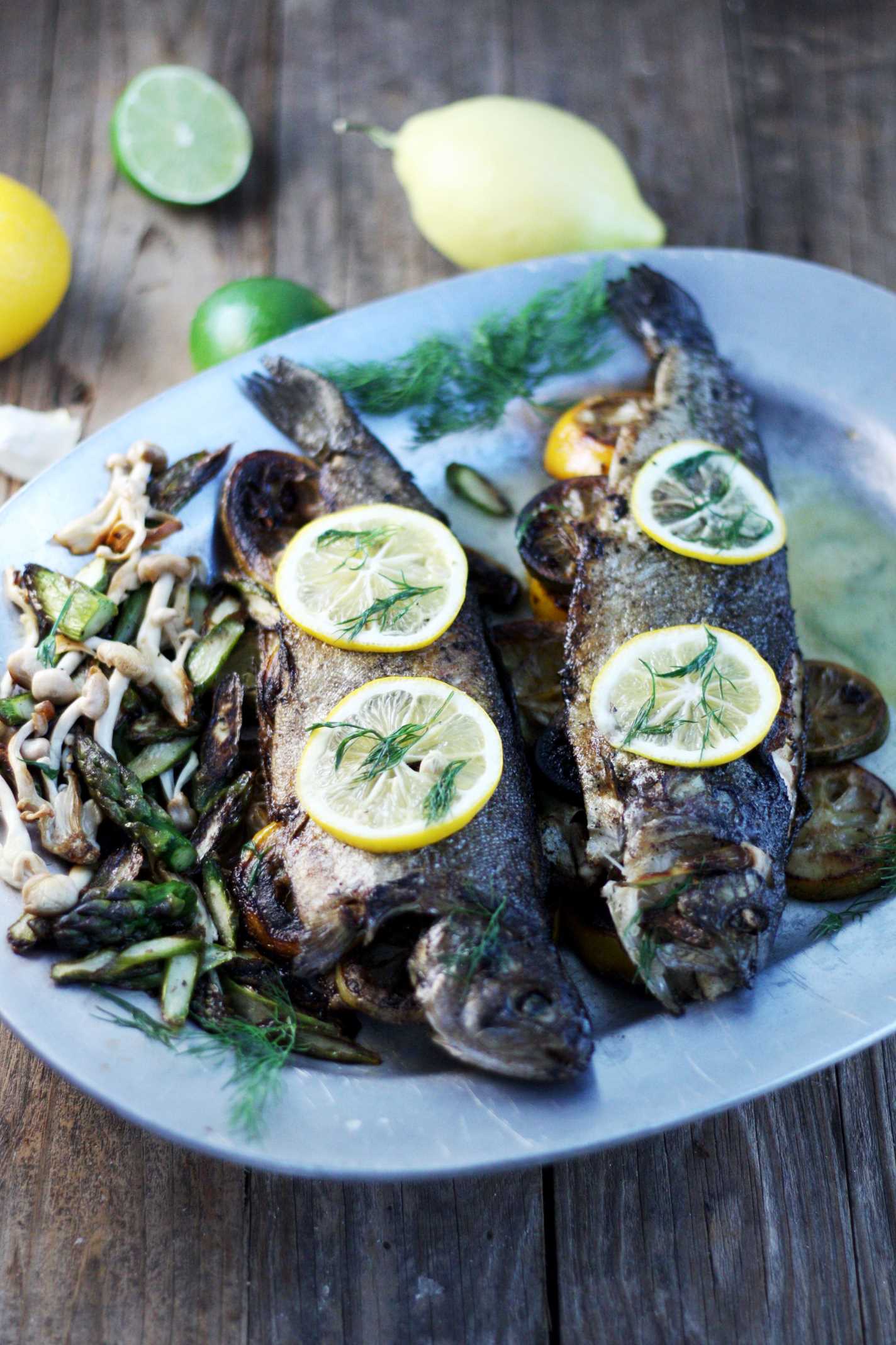 trout, asparagus and mushrooms arranged on pewter platter