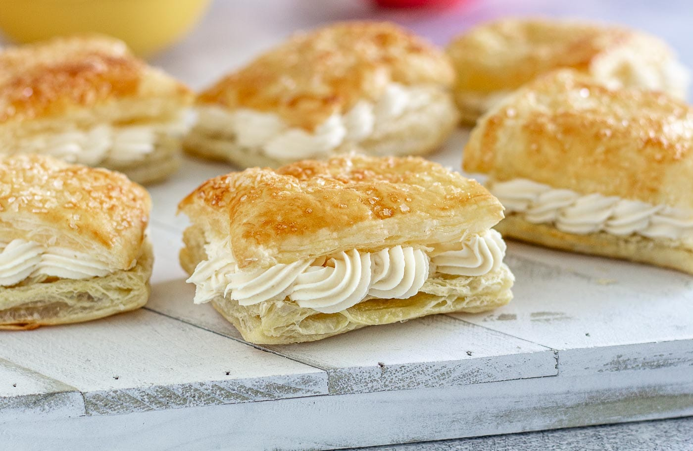 Pastry filled with cream filling on a white board.