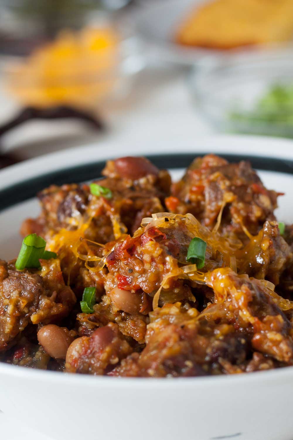 venison chili heaped up in white bowl, close up