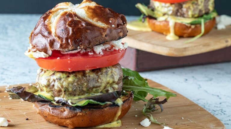 Juicy lamb burger on a pretzel bun.