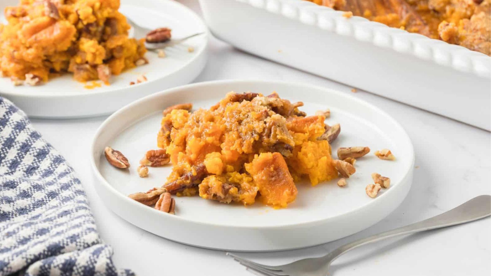 Sweet potato souffle on white plates.