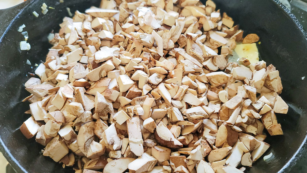 Mushrooms added to the skillet.