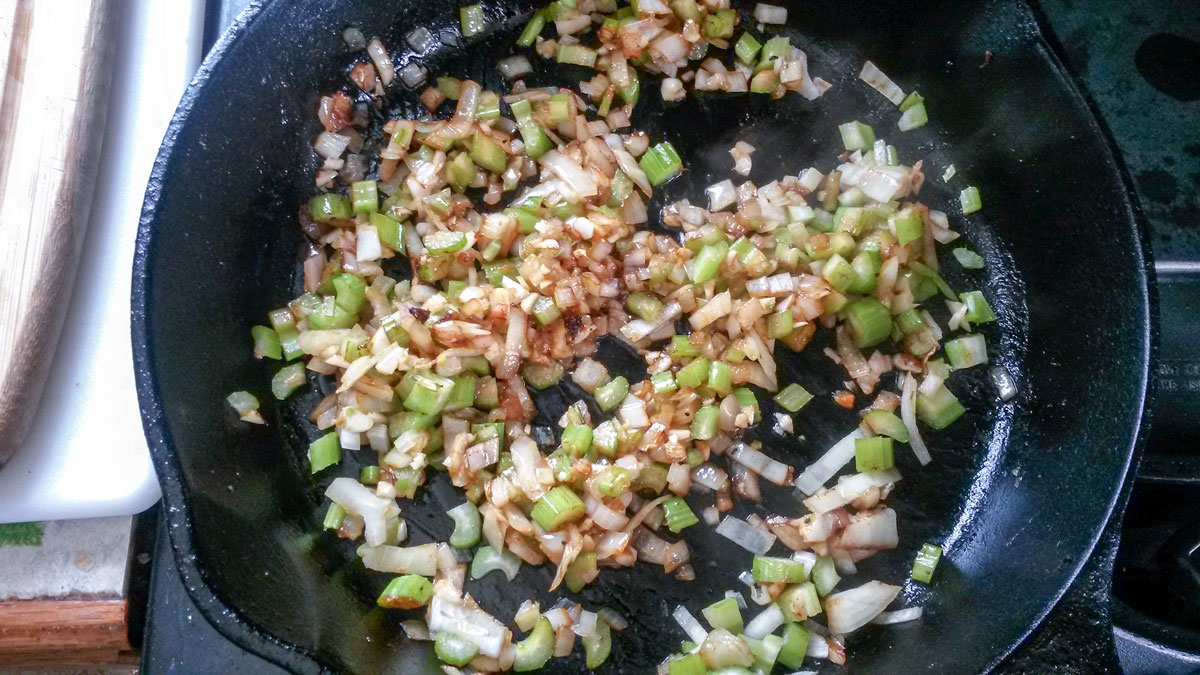 Celery and onion cooked to golden brown in skillet.