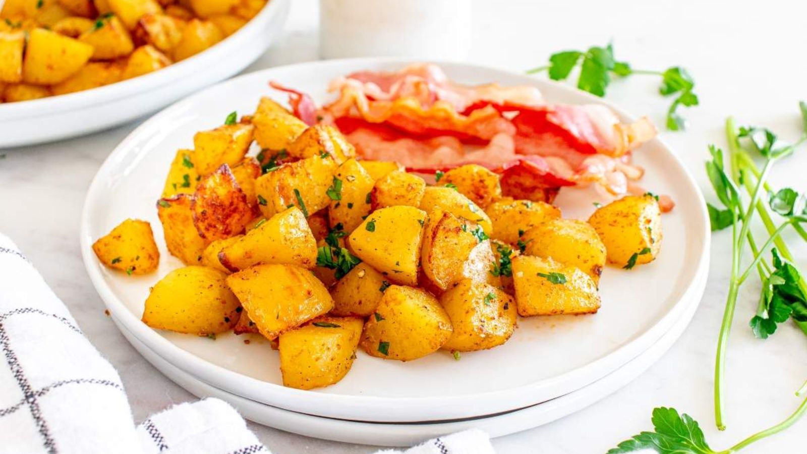 Potatoes and bacon on a plate.