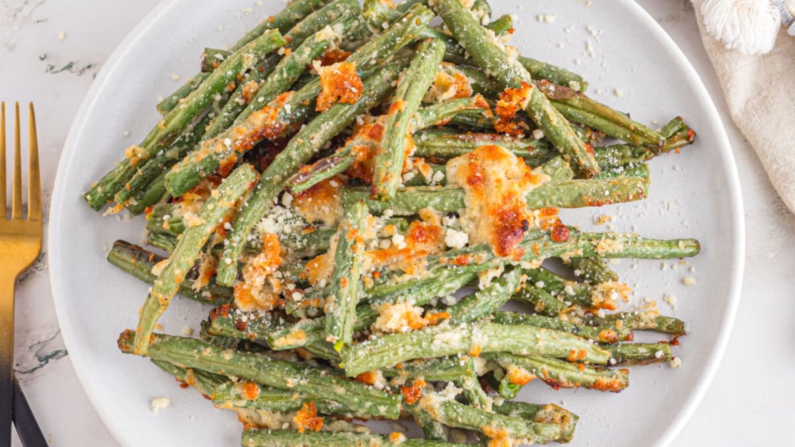 Green beans with parmesan on a plate.