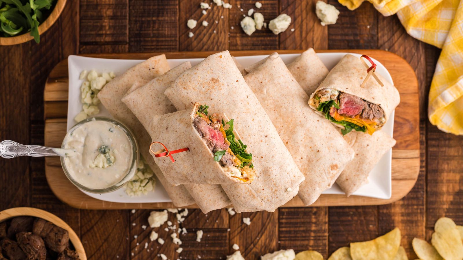 Steak wraps on a wooden board.