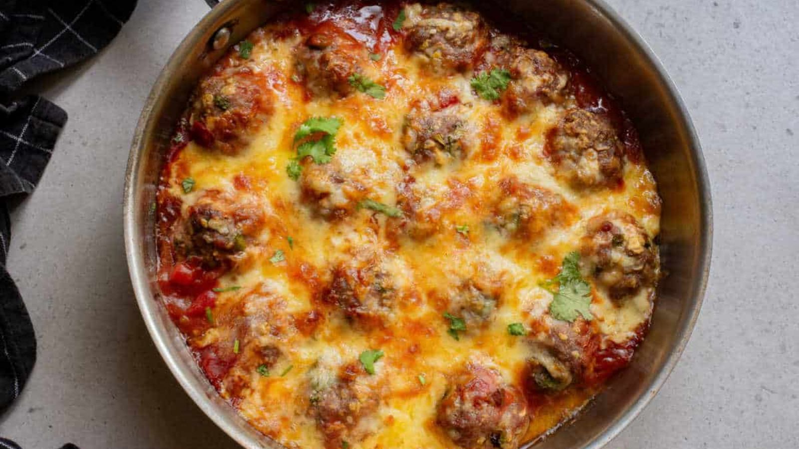 Baked meatballs in a pan.