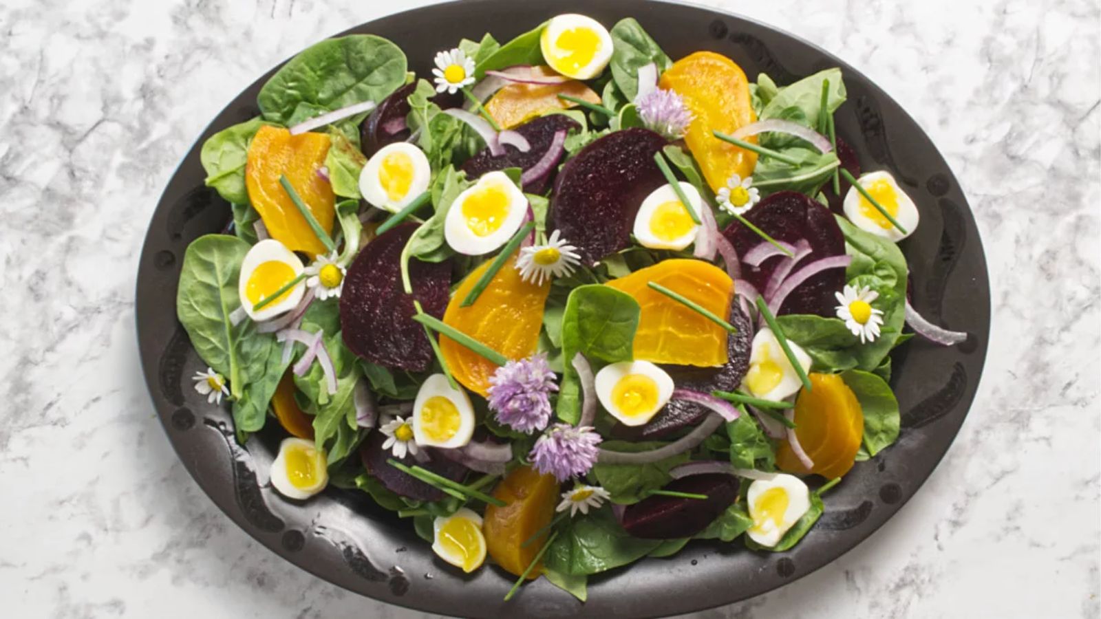 Spinach and arugula salad on a plate.