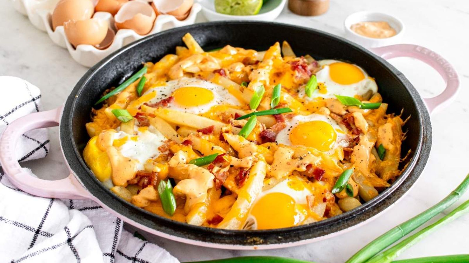 Fries with sunny side up eggs on top.