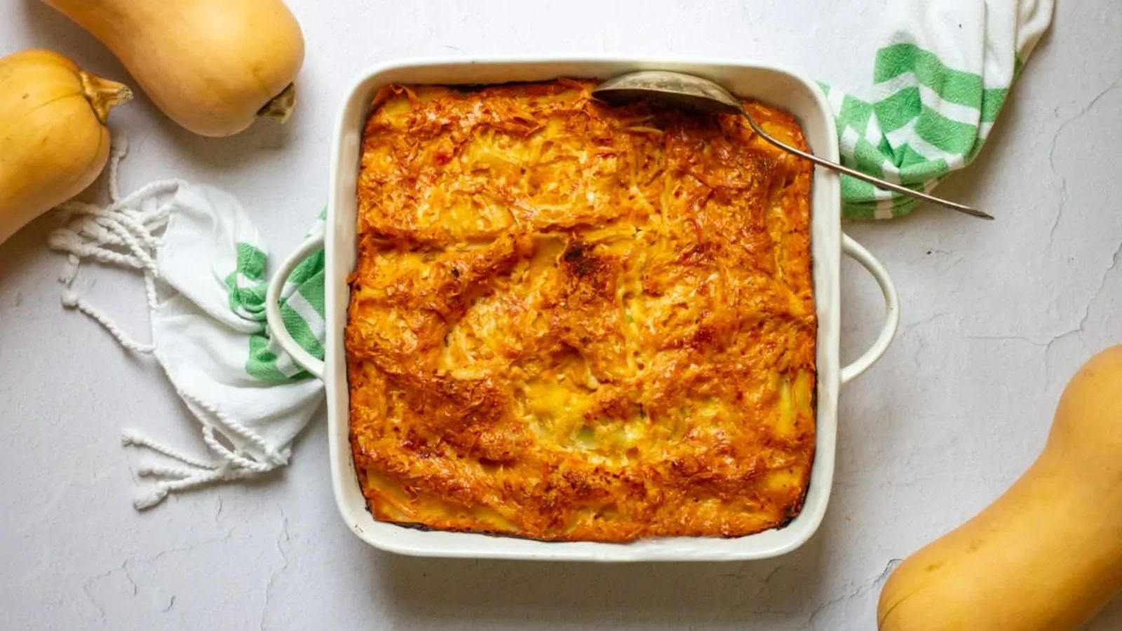 Squash lasagna with whole squash on the sides.