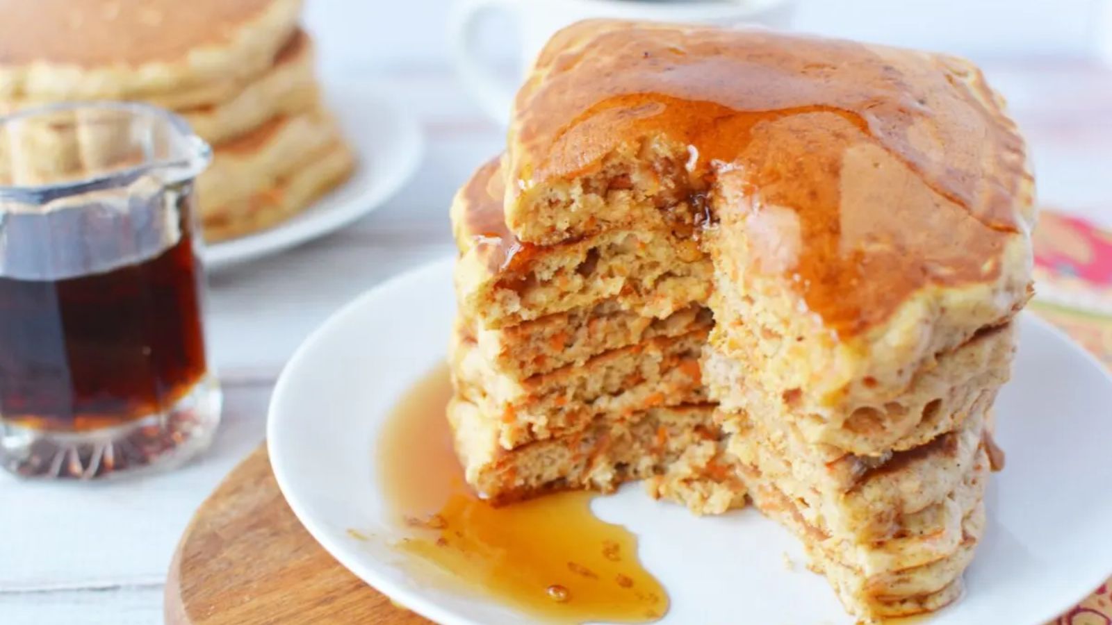 Stack of carrot pancakes with syrup.