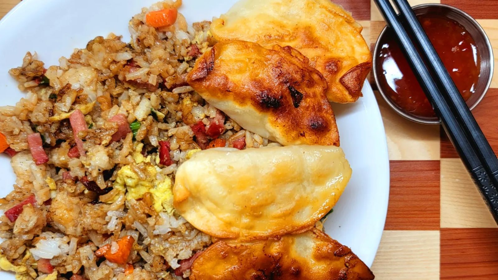 Fried rice with dumplings on a plate.
