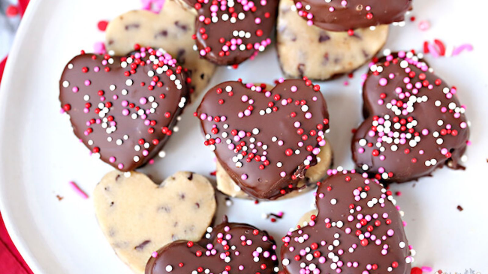 Heart shaped cookies with chocolate and sprinkles.
