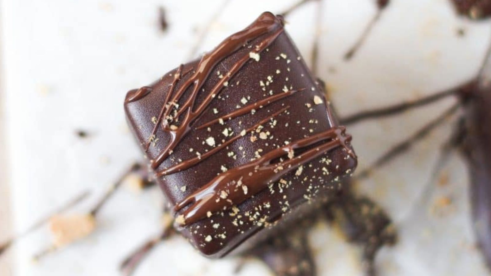 A chocolate bite with chocolate drizzle.