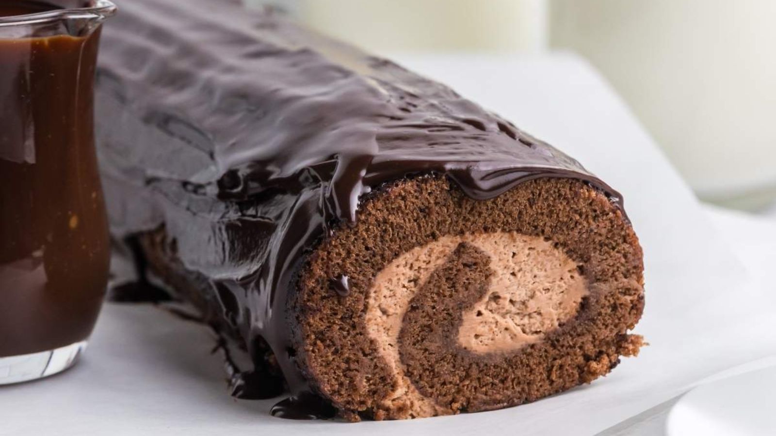 Chocolate roll cake on a plate.