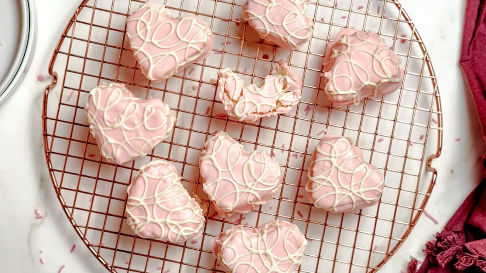 Little heart cakes on a cooling rack.