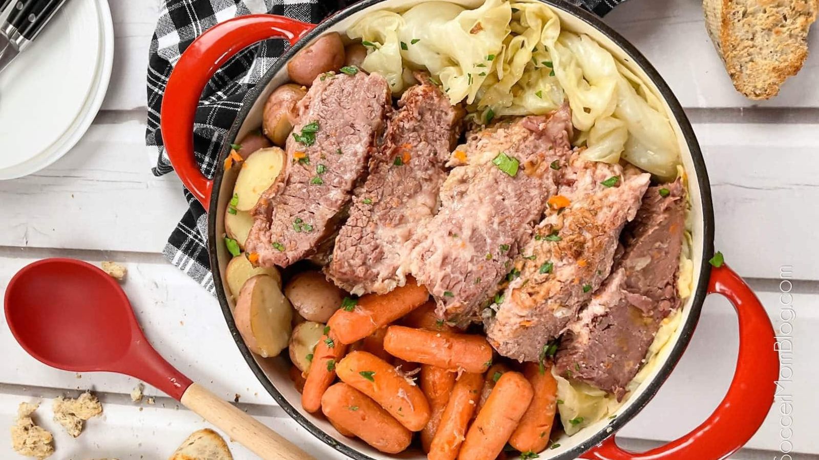 Corned beef, potatoes, carrots and cabbage in a pot.