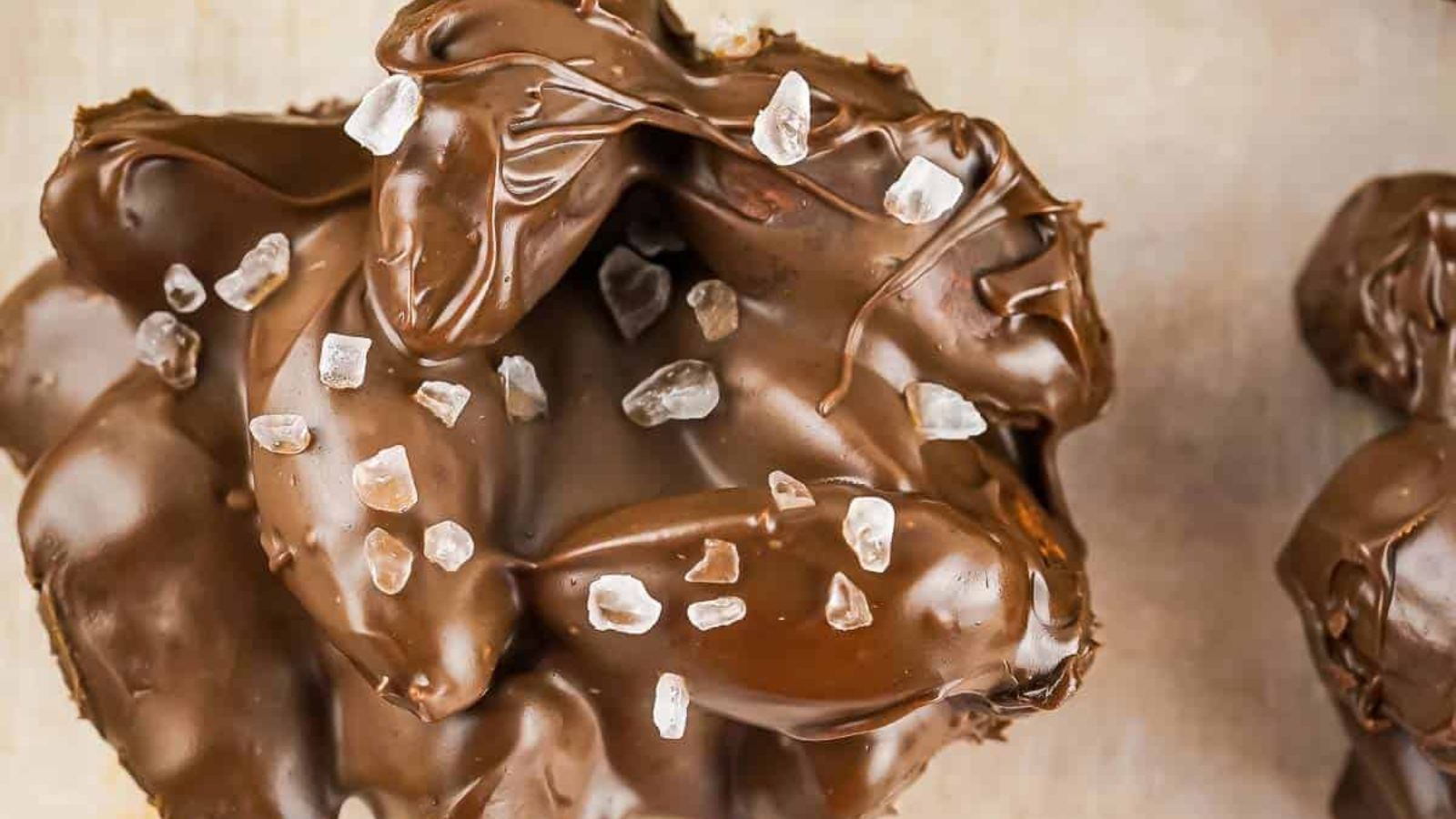 Close up shot of chocolate almond cluster with salt.