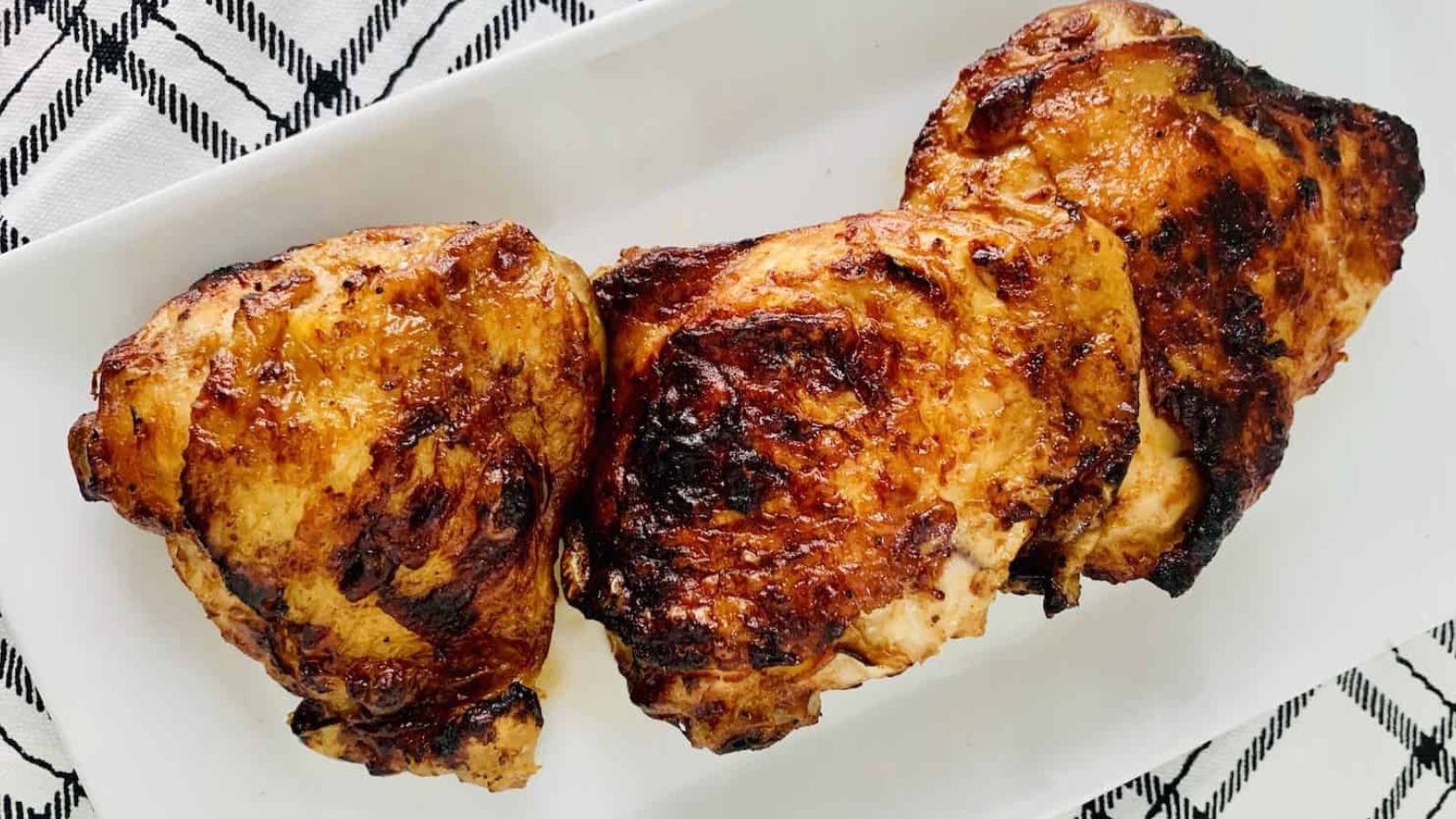 BBQ chicken thighs on a plate.